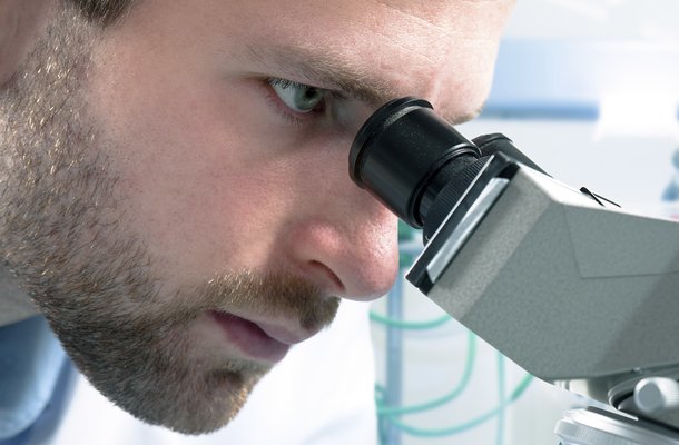 Microscope and scientist people istock